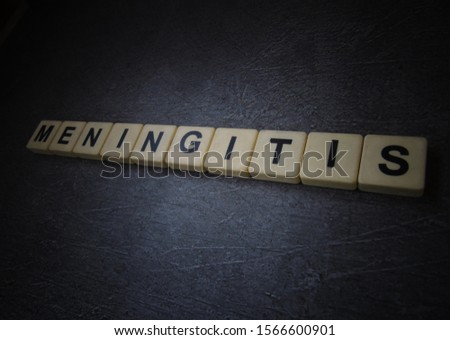 Meningitis, word cube with background.