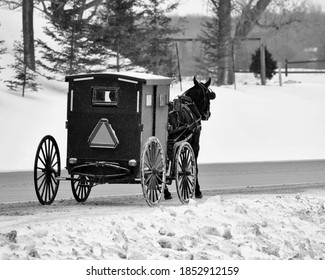 A Mennonite Horse And Buggy In Transport On A Snowy Winter Afternoon.