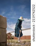 Mennonite woman working in her garden 