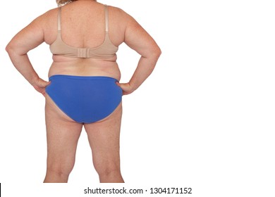 Menopausal woman with weight gain after brachioplasty, panniculectomy, abdominoplasty and mummy makeover. Full body back view hands on hips, copy space right. Makeover inspiration, faded scars. 