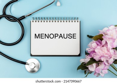 Menopause Text On Note Pad On Top Of Blue Office Desk - Health Care And Medical Concept, Flay Lay