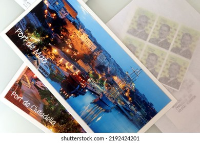 Menorca (Minorca), Spain - July 6 2022: Postcards Of The Most Famous Places Of Menorca And Postage Stamps. Postcards Prepared For Sending. Holiday Postcards