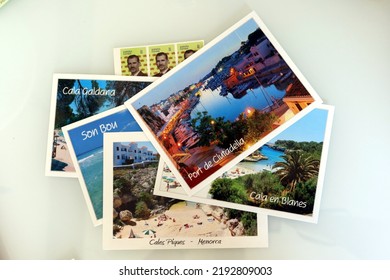 Menorca (Minorca), Spain - July 6 2022: Postcards Of The Most Famous Places Of Menorca And Postage Stamps. Postcards Prepared For Sending. Holiday Postcards