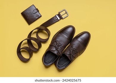 Men's accessories on beige background. Leather brown classic shoes, wallet and belt. Casual design, fashion concept. Flat lay, top view - Powered by Shutterstock