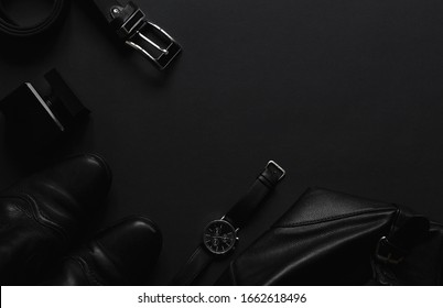 Men's accessories  on the black table with top view with copy space.
Fashion backgroun for men, luxury concept.
Minimal black trendy 2020.