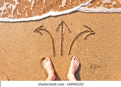 Men's Bare Feet In The Sand And Arrows