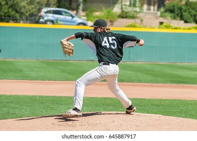 Mens' baseball pitcher winding up to generate power. - Powered by Shutterstock