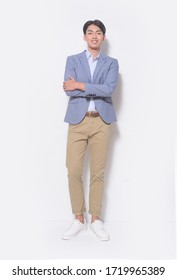 Men's Beauty, Fashion. Handsome Full Body Young Man In Blue Suit With Khaki Pants , , Arms Folded Posing At Studio


