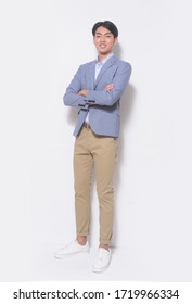 Men's Beauty, Fashion. Handsome Full Body Young Man In Blue Suit With Khaki Pants , , Arms Folded Posing At Studio


