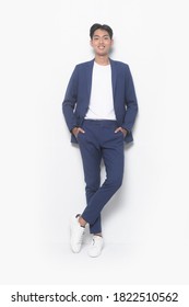 Men's Beauty, Fashion. Handsome Full Body Young Businessman Wearing White Shirt And Blue Pants With Sneakers Shoes Hands In Pockets,posing In Studio