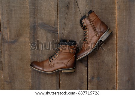 men's boots shoes on a wooden background.