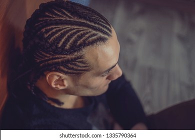 men's braids male braids close-up, hair drawing, creative hairstyle, background, hair, a man looks into the distance cornrows
