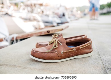 Mens brown loafers shoe on a pier head for Yacht Marina