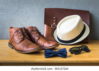 Men's casual, bow tie with sunglasses and shoes on wooden over wall grunge background - Shutterstock ID 301157264