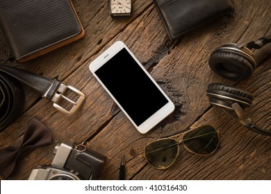 Men's casual  Old camera,mobile phone and supplies on office wooden table. - Powered by Shutterstock