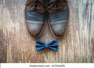 Men's Casual Outfits With Brown Shoes And Blue Bowtie On Rustic Wooden Background