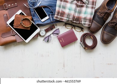 Men's casual outfits with man clothing and accessories on rustic wooden background, travel concept - Powered by Shutterstock