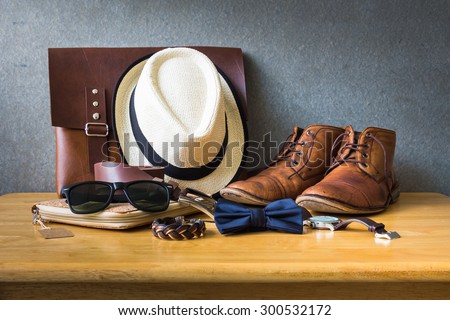 Men's casual outfits on wooden table over wall grunge background