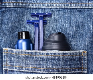 Mens Cosmetics. Shaving Foam, Disposable Razors And Aftershave Lotion In Jeans Pocket. Basic Skin Care Cosmetic Products And Accessories For Men. Toiletry And Cosmetic Travel Kit