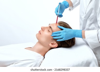 Men's cosmetology. Beautician makes a man a rejuvenation injection procedure on his face. - Shutterstock ID 2168298337