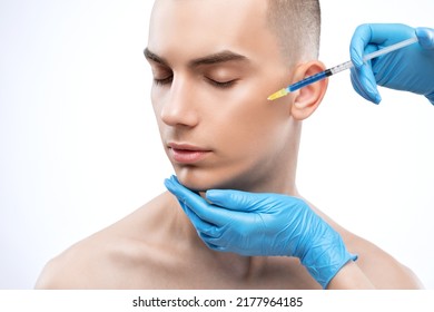 Men's cosmetology. Beautician makes a man a rejuvenation injection procedure on his face. - Shutterstock ID 2177964185