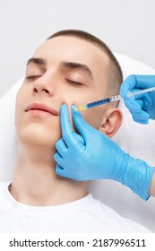 Men's cosmetology. Beautician makes a man a rejuvenation injection procedure of a handsome young man in a beauty salon. - Shutterstock ID 2187996511