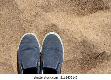 Men's Fabric Slip-ons In The Sand Background. Lightweight Shoes Without Laces