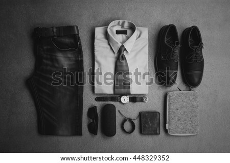 Men's fashion, casual outfits with accessories, flat lay, top view on gray grunge background, black and white