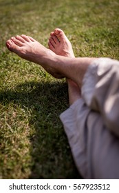 Mens Feet On The Grass In The Park In Summer