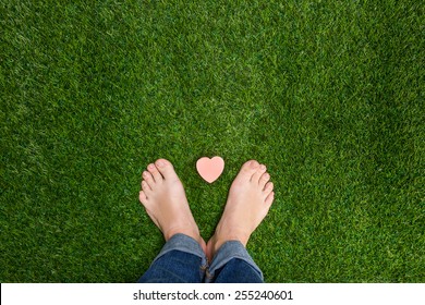 Mens Feet Standing On Grass With Small Heart