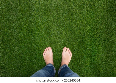 Mens feet standing on grass