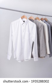 Men's Four Suit With Long Sleeved White Shirt On Hanger-gray Background