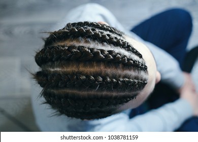 Men's Hairstyle Corn Rows, Straight Braids, Thick, View From The Top Close Up, Weaving On The Beach