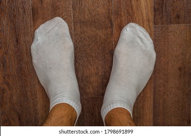 Mens Hairy Legs In Short White Socks On The Floor