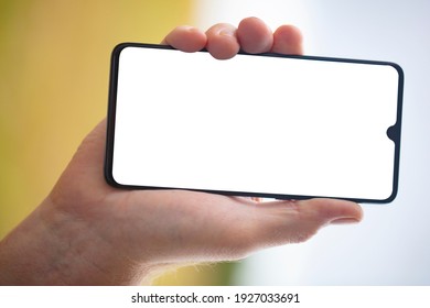 Mens Hand holding a smartphone with blank screen