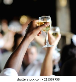 Men's Hand Holding Wine Glass At Festive Event