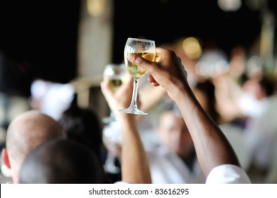 Men's Hand Holding Wine Glass At Festive Event