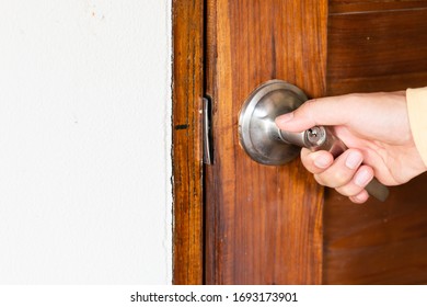 Men's Hand Opens Wooden Door Home. Close Up.