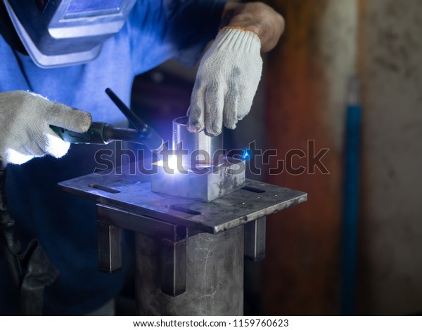 Men\'s hands with argon\
welding machine.  repair pipe stainless argon welding industrial\
construction