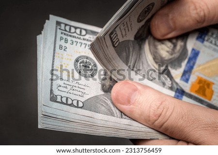 Men's hands counting one hundred American dollars banknotes. American 100 dollar bills. Hand counting money. Cash counting. Selected focus, close-up