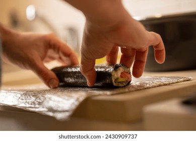 mens hands crafting sushi rolls - Powered by Shutterstock