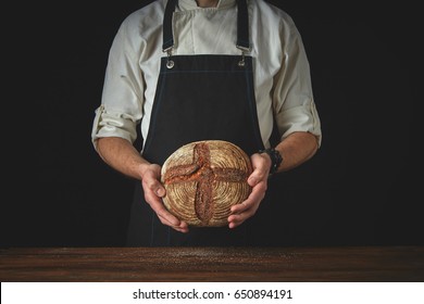 Men's hands hold bread - Powered by Shutterstock