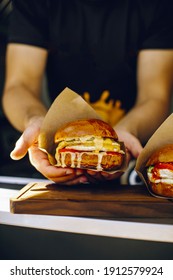 
Mens Hands Holding A Burger