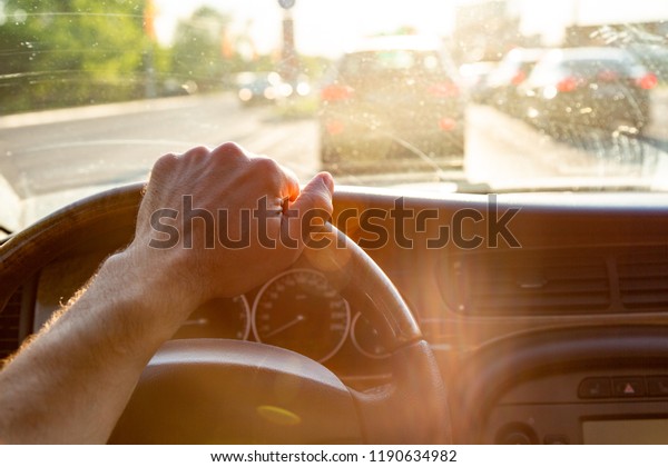 Men\'s hands on the wheel of\
the car