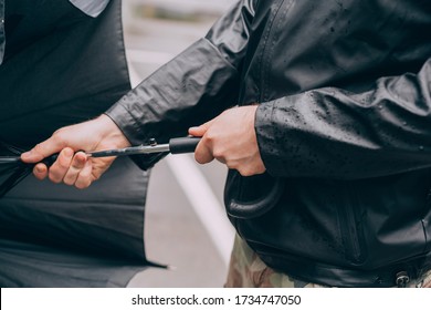 Men's Hands Open A Black Umbrella
