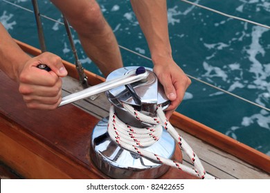 Men's Hands Pull The Rope By A Winch