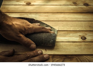 Men's Hands With Sandpaper, Skinning Wooden Boards