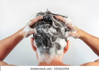 Men's Hands Wash Their Hair With Shampoo And Foam On A White Background, Rear View