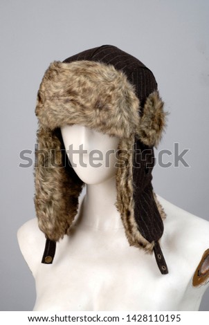 Men's hats made of long furry natural animal feathers winter hats male accessories lifeless model head on white background fashion trend textile industry.