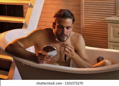 Mens Heals Body Care. Grooming, Hygiene, Health. Bearded Man Shave With Razor In Bath In Bathroom. 